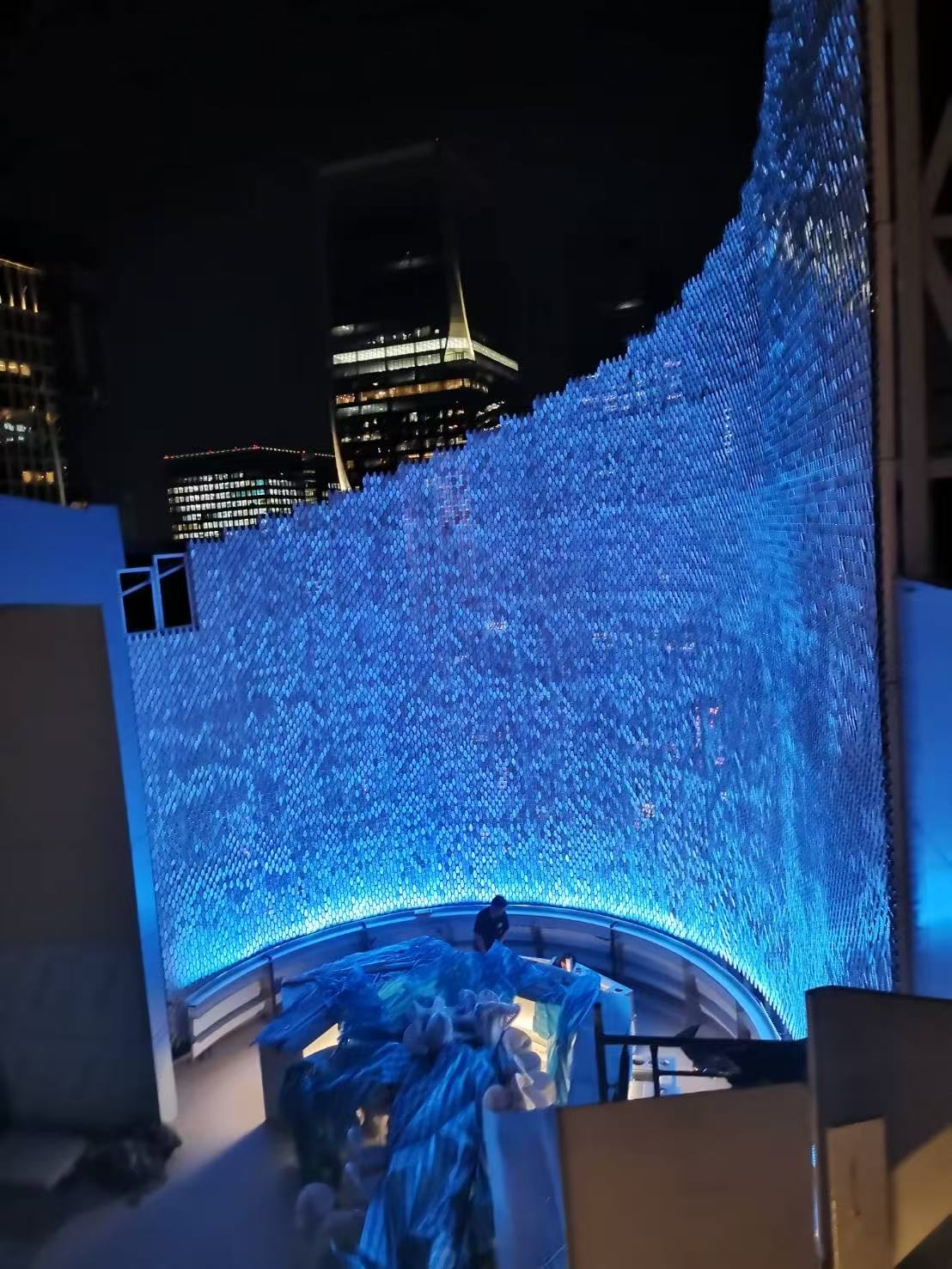 SO Bangkok Hotel illuminated curved wind-driven kinetic facade at night